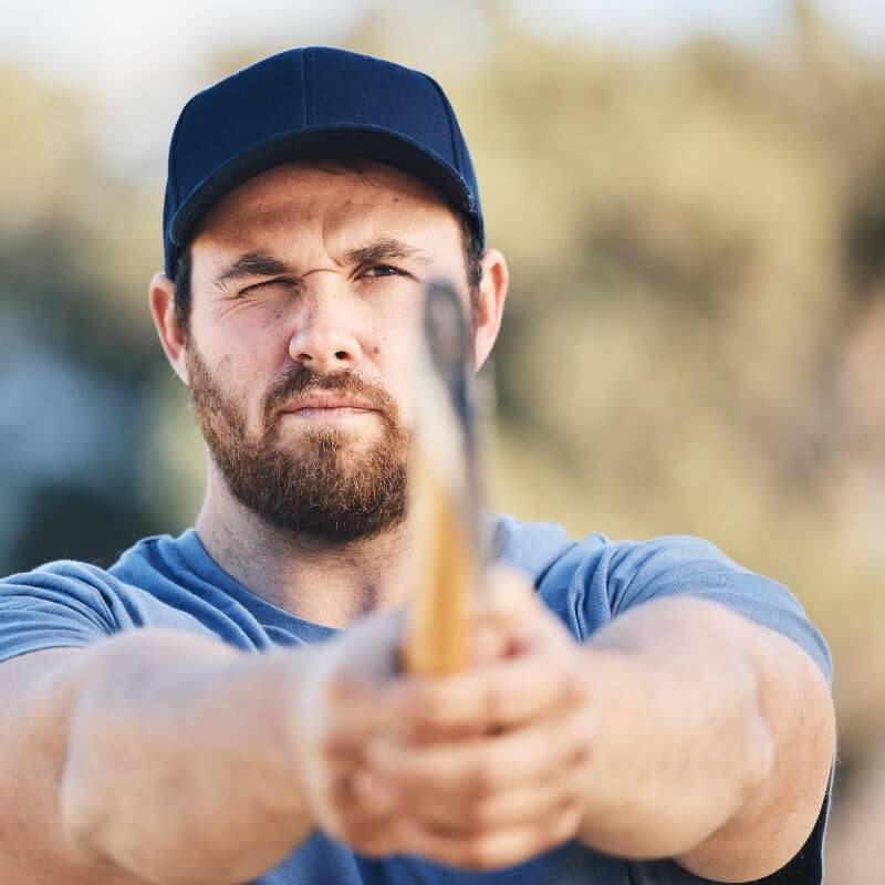 profile picture of a man squinting and aiming with his axe at an axe throwing target